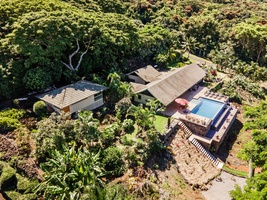 Private tropical estate nestled in lush jungle surroundings with swimming pool and extensive landscaping.