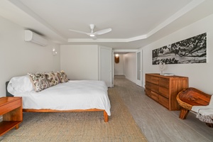 King bed and custom art elevate this peaceful, light-filled bedroom.