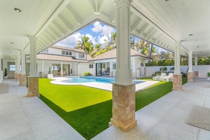 Covered lanai with expansive vaulted ceilings overlooking the central courtyard.