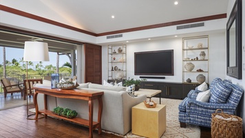 The living room offers a comfortable space with ample seating and a large TV, perfect for unwinding with loved ones.