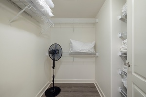 Your spacious walk-in closet offers ample wire shelving and storage space, keeping you organized throughout your stay.