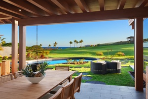 Covered lanai dining area with grill and evening breeze.