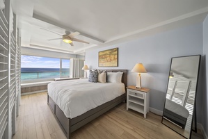 Wake up to stunning ocean views in this serene bedroom where gentle sea breezes and soft lighting create your perfect retreat.