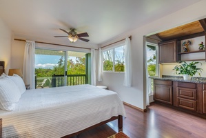 This bedroom has a queen bed, ceiling fan, and ensuite bath