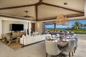 Vaulted ceilings with mahogany trim and cove lighting and an elegant formal dining table for eight.