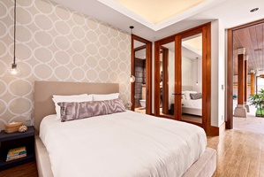 Guest bedroom with queen bed and soft neutral tones.