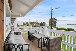 Property exterior balcony offers partial water views through nearby trees and power lines.