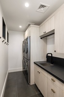 A convenient laundry room with premium appliances ensures comfort during longer stays at the estate.