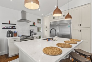Sleek kitchen with stainless steel appliances and a spacious island, perfect for casual dining.