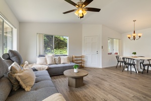 Sink into the plush sectional sofa while ceiling fans keep you cool in this bright, open living space with garden views.