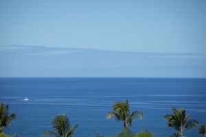 Endless blue waters and distant clouds meet at the horizon in this breathtaking ocean panorama.