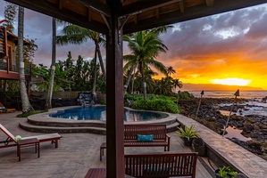 Relax by the serene pool and lounge area while enjoying a breathtaking ocean sunset.