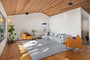 Cozy up in the living room with warm wood accents and plenty of natural light.