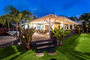 Charming front view of the home with lush landscaping and open-air design.