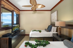The third guest bedroom has two twin beds, a TV and a view.
