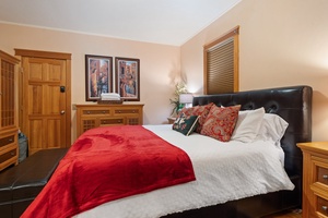 A cozy bedroom adorned with holiday-themed linens and a warm ambiance perfect for festive nights.