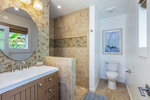 Refresh in the ensuite bathroom featuring custom tilework and a walk-in shower for added comfort.