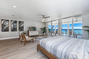 Expansive primary suite with king bed, ocean views, and access to the private lanai.