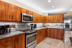 Gather around granite countertops while breakfast, happy hour, or a sunset dinner comes together with an ocean view just beyond.