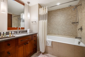 The third guest bathroom includes a shower-tub combo, perfect for relaxing soaks after a day of hiking or surfing.