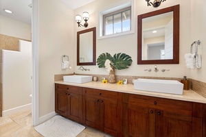 Stylish third bathroom vanity featuring dual sinks and classic wooden cabinetry.