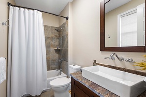Full guest ensuite bath features a tub/shower combo, ideal for families with young children.