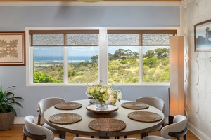 Gather around a round dining table with wraparound windows offering ocean and hillside views—a daily reminder of paradise.