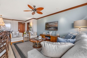 Sink into plush seating while tropical ceiling fans keep you cool in this elegantly appointed living room.