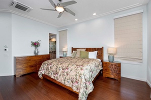 The primary bedroom with warm lightings and an airy ambiance.