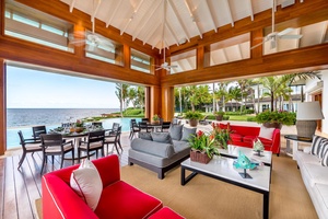 Vibrant oceanfront lounge, with comfortable seating and tropical decor.