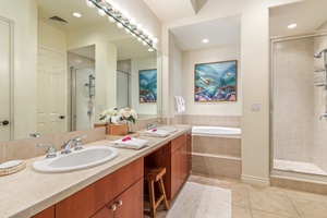 Primary bath with dual vanity, oval soaking tub and separate walk-in shower.