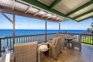 Lanai stretches along the home, offering multiple spaces to dine, lounge, and watch the waves.