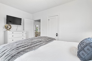 The main-level bedroom offers a queen-size bed, soft textures, and calm tones for deep rest.