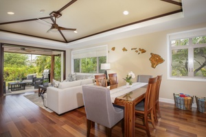 The airy great room brings everyone together for meals, games, or movie nights in true Hawaiian comfort.