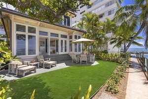 Oceanside lawn with Diamond Head Surf House—relax, dine, or watch surfers just steps away.