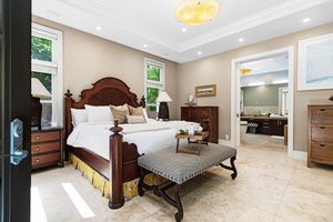 California king suite with lounge bench and soft lighting.