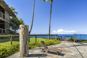 Tropical beachfront property with palm trees and stunning ocean views under clear blue skies.