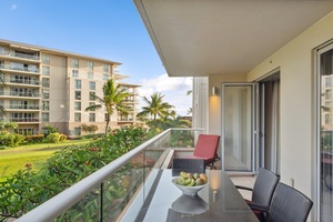 Sip sunset cocktails from the shaded lanai at Honua Kai Konea 204 with partial ocean and garden views.
