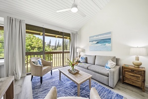 Sliding doors open off the living room toward the palms, letting afternoon light pour in.