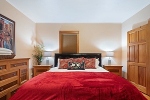 Cozy primary bedroom adorned with festive red bedding, perfect for a holiday retreat.