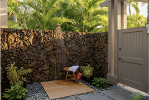 Nature awaits with a private outdoor shower under swaying palm trees.