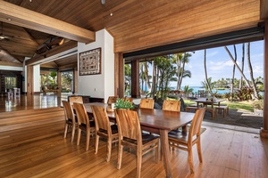 Gather around this elegant dining table where tropical breezes flow through open walls, creating perfect moments for memorable meals with ocean views.