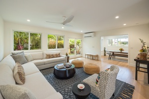 Step into serenity in the heart of the home—an expansive lounge framed by lush garden views and island breezes.