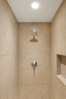 The ensuite bath has a separate walk-in shower.