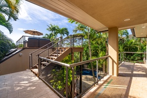 Step onto your private lanai and soak in tropical paradise views. Modern railings frame lush palms while stairs lead to your rooftop escape.