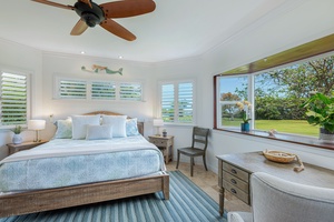 Bright and airy primary bedroom with corner windows and a coastal-inspired design for a restful night's sleep.