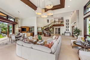 Expansive living space with high ceilings and panoramic views of the lush surroundings.
