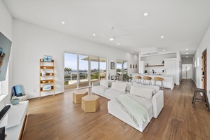 Lounge in the airy living area with seamless access to the outdoor lanai.