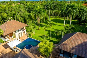 Bask in the beauty of the garden views, complete with a sparkling pool and palm trees.