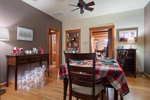 A charming dining area dressed with plaid tablecloths and Christmas decor.